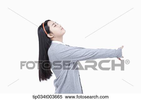 Stock Photography - a female student stretching her neck and arms. Fotosearch