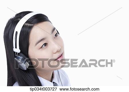 a female student wearing a headphone View Large Photo Image Stock Photo - a female student wearing a headphone. Fotosearch