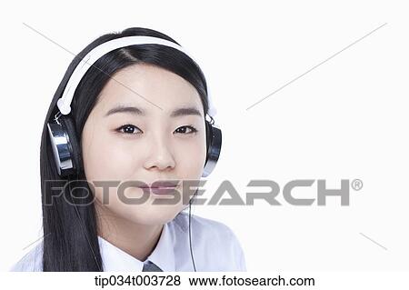 a female student wearing a headphone View Large Photo Image Stock Photo - a female student wearing a headphone. Fotosearch