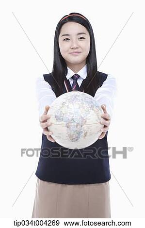 Stock Photo - a female student wearing school uniform holding a globe with two hands. Fotosearch