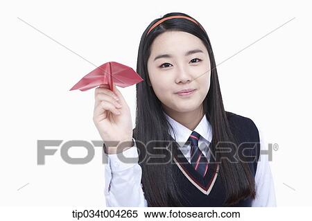 Stock Photography - a female student wearing school uniform ready to throw a paper airplane . Fotosearch