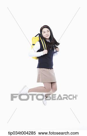 Stock Photography - a female student wearing school uniform and a school bag jumping . Fotosearch