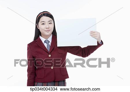 Picture - a female student with school uniform holding an empty white paper . Fotosearch