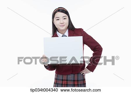 a female student with school uniform holding an empty white paper View Large Photo Image Stock Image - a female student with school uniform holding an empty white paper . Fotosearch