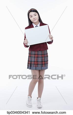 a female student with school uniform holding an empty white paper View Large Photo Image Stock Image - a female student with school uniform holding an empty white paper . Fotosearch