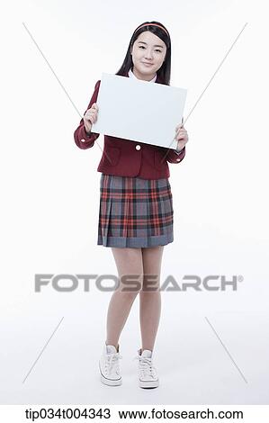 a female student with school uniform holding an empty white paper View Large Photo Image Stock Image - a female student with school uniform holding an empty white paper . Fotosearch