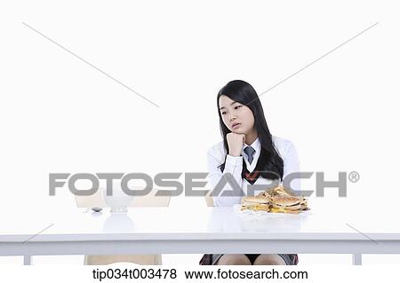 a female student with school uniform sitting in front of burgers staring at a bowl with rice View Large Photo Image Stock Photo - a female student with school uniform sitting in front of burgers staring at a bowl with rice. Fotosearch