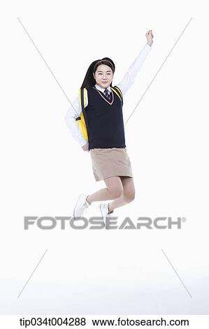 a female student with school uniform and a school bag jumping while raising her arm View Large Photo Image Stock Photo - a female student with school uniform and a school bag jumping while raising her arm. Fotosearch