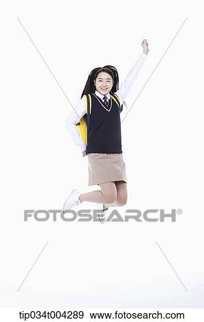 a female student with school uniform and a school bag jumping while raising her arm View Large Photo Image Stock Photo - a female student with school uniform and a school bag jumping while raising her arm. Fotosearch