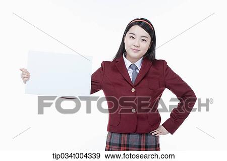 Stock Photo - a female student with school uniform holding an empty white paper . Fotosearch