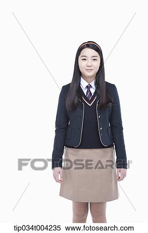 Stock Photography - a female student with school uniform standing up straight. Fotosearch