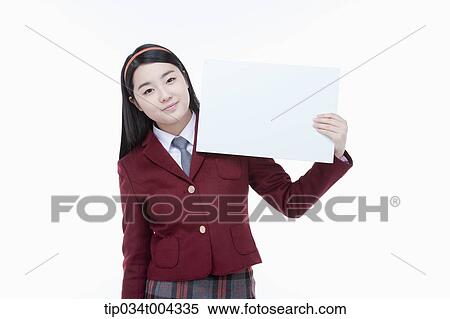 Stock Photography - a female student with school uniform holding an empty white paper . Fotosearch