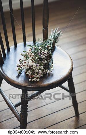 a flower bundle on a chair View Large Photo Image Stock Photography - a flower bundle on a chair. Fotosearch