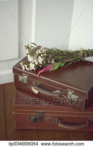 a flower bundle on brown suit cases View Large Photo Image Picture - a flower bundle on brown suit cases. Fotosearch