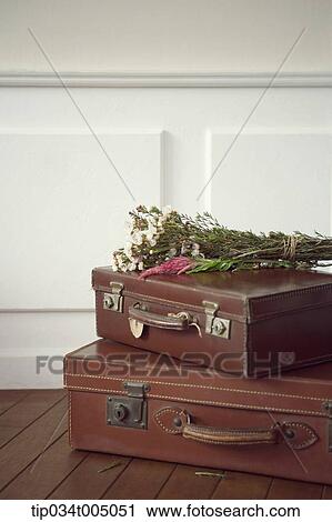 a flower bundle on brown suit cases View Large Photo Image Stock Image - a flower bundle on brown suit cases. Fotosearch