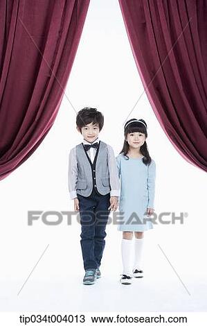 a girl and a boy hand in hand standing on a stage with red curtains View Large Photo Image Stock Image - a girl and a boy hand in hand standing on a stage with red curtains . Fotosearch