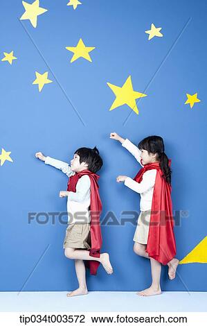 a girl and a boy posing like a superman in their side ways View Large Photo Image Stock Image - a girl and a boy posing like a superman in their side ways. Fotosearch