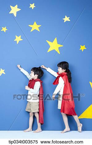Stock Photography - a girl and a boy posing like a superman in their side ways. Fotosearch