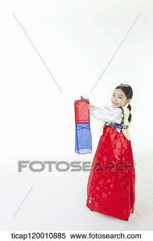 Stock Photography - a girl in Hanbok holding a paper lamp . Fotosearch