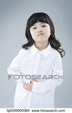 Picture - a girl in white shirt looking at you. Fotosearch