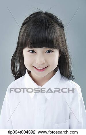 Stock Image - a girl in white shirt smiling. Fotosearch