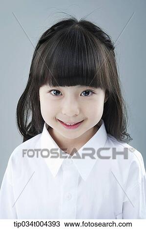 Stock Image - a girl in white shirt smiling. Fotosearch