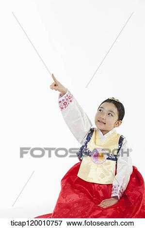 a girl pointing up in the side ways wearing a Hanbok dress View Large Photo Image Stock Photo - a girl pointing up in the side ways wearing a Hanbok dress. Fotosearch