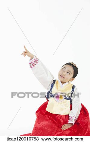 a girl pointing up in the side ways wearing a Hanbok dress View Large Photo Image Stock Photo - a girl pointing up in the side ways wearing a Hanbok dress. Fotosearch