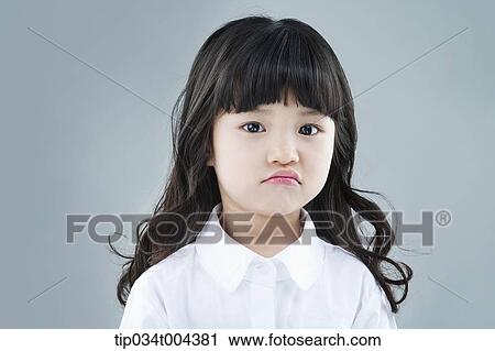 a girl posing a grumpy face View Large Photo Image Stock Image - a girl posing a grumpy face. Fotosearch