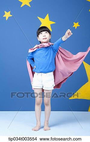 a girl posing like a superwoman with a pink cape around her neck View Large Photo Image Picture - a girl posing like a superwoman with a pink cape around her neck. Fotosearch