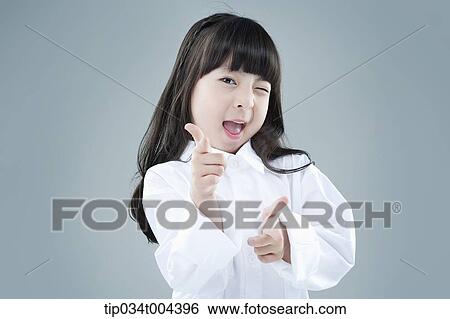 a girl posing while winking View Large Photo Image Stock Photograph - a girl posing while winking . Fotosearch