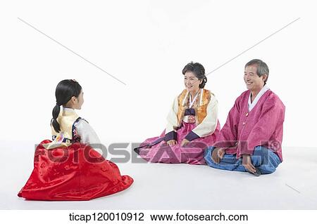 a girl sitting in front of parents wearing Hanbok View Large Photo Image Stock Image - a girl sitting in front of parents wearing Hanbok. Fotosearch