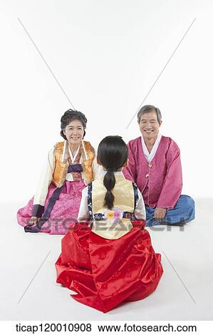 a girl sitting in front of parents wearing Hanbok View Large Photo Image Stock Photo - a girl sitting in front of parents wearing Hanbok. Fotosearch