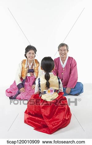 a girl sitting in front of parents wearing Hanbok View Large Photo Image Stock Photo - a girl sitting in front of parents wearing Hanbok. Fotosearch