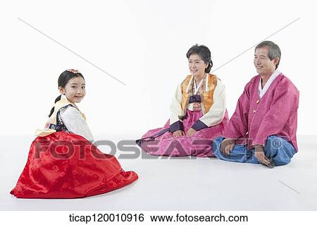 a girl sitting in front of parents wearing Hanbok View Large Photo Image Stock Photograph - a girl sitting in front of parents wearing Hanbok. Fotosearch