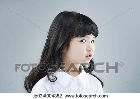 Stock Image - a girl turning her head away from you . Fotosearch