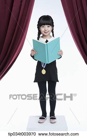 a girl wearing a medal holding on a stage View Large Photo Image Stock Image - a girl wearing a medal holding on a stage . Fotosearch