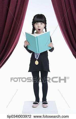 Stock Image - a girl wearing a medal holding on a stage . Fotosearch