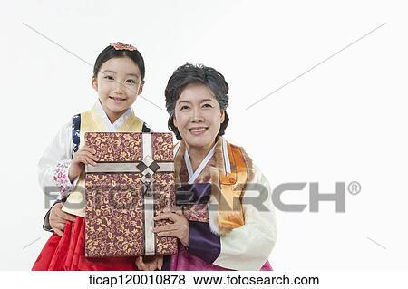a girl with grandmother in Hanbok holding a present View Large Photo Image Stock Photo - a girl with grandmother in Hanbok holding a present . Fotosearch