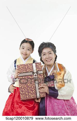 a girl with grandmother in Hanbok holding a present View Large Photo Image Stock Photo - a girl with grandmother in Hanbok holding a present . Fotosearch