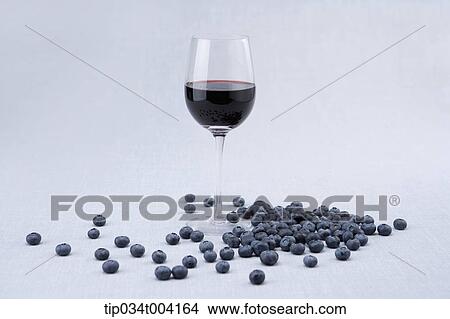 a glass of red wine blueberries rolling around View Large Photo Image Picture - a glass of red wine blueberries rolling around . Fotosearch