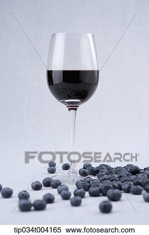a glass of red wine blueberries rolling around View Large Photo Image Stock Photography - a glass of red wine blueberries rolling around . Fotosearch