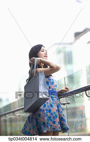 a lady in dress looking out in a building balcony View Large Photo Image Picture - a lady in dress looking out in a building balcony . Fotosearch