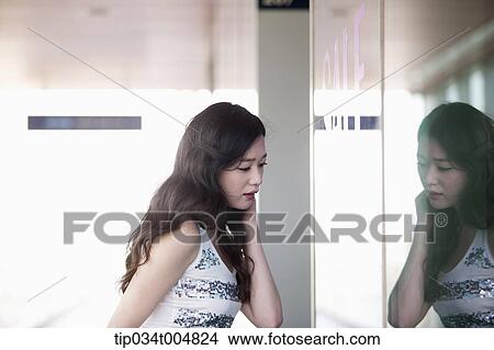 a lady looking on a show window View Large Photo Image Picture - a lady looking on a show window . Fotosearch