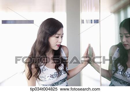 a lady looking on a show window View Large Photo Image Stock Photography - a lady looking on a show window . Fotosearch