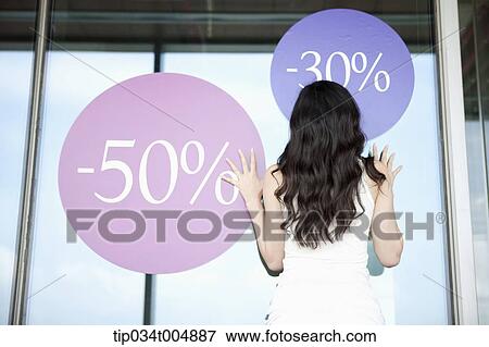 a lady touching a show window with sale signs View Large Photo Image Stock Photo - a lady touching a show window with sale signs. Fotosearch