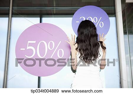 a lady touching a show window with sale signs View Large Photo Image Stock Photo - a lady touching a show window with sale signs. Fotosearch