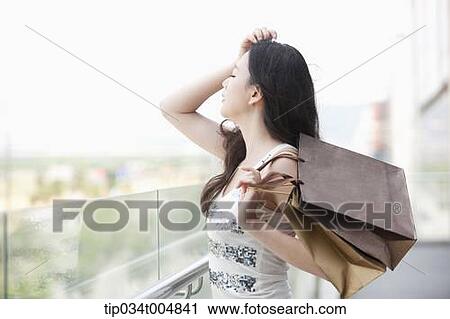 a lady with shopping bags posing while eyes closed View Large Photo Image Stock Image - a lady with shopping bags posing while eyes closed . Fotosearch