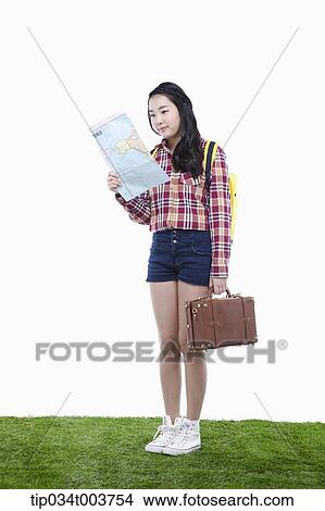 a lady with suitcase holding a map View Large Photo Image Picture - a lady with suitcase holding a map . Fotosearch
