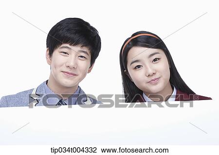a male and female students with school uniform holding an empty paper View Large Photo Image Stock Image - a male and female students with school uniform holding an empty paper . Fotosearch
